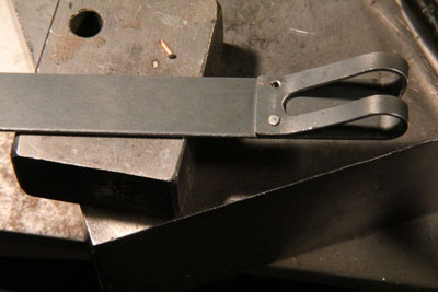 The Zundapp KS601 battery strap with one rivet, next one waiting.